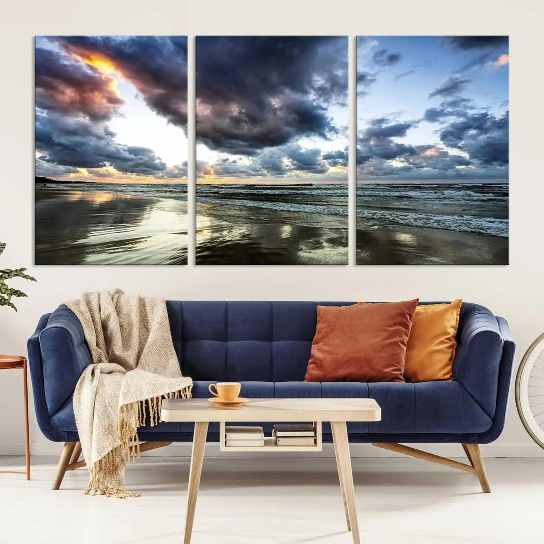 A breathtaking "Stormy Ocean Sky Wall Art" canvas print beautifully depicts stormy ocean skies and waves at sunset, with reflections shimmering on wet sand.