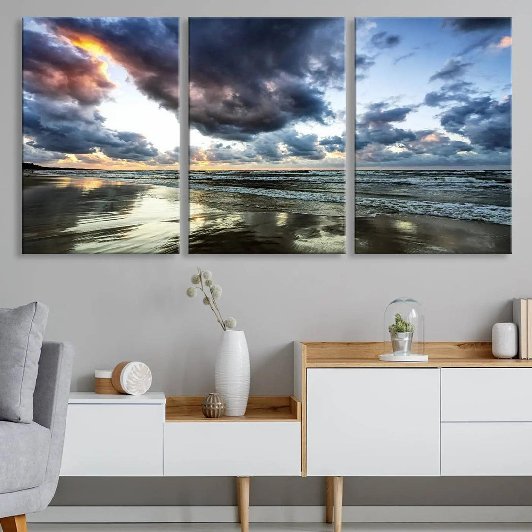 A breathtaking "Stormy Ocean Sky Wall Art" canvas print beautifully depicts stormy ocean skies and waves at sunset, with reflections shimmering on wet sand.