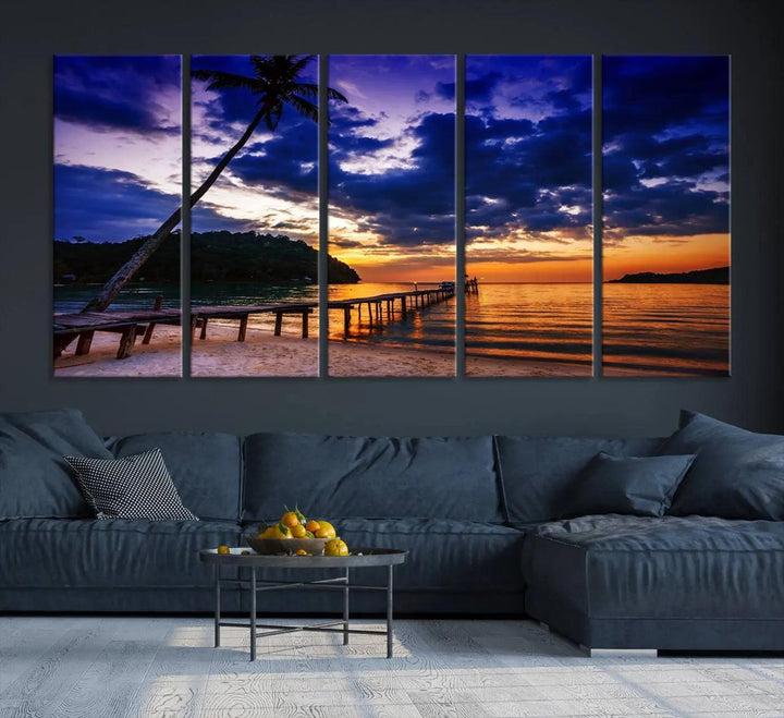 A stunning Sunset Beach Pier Wall Art, featuring a Tropical Island Sunset Canvas Print with palm trees and a pier seascape triptych, graces the wall, capturing the essence of coastal-inspired interiors.