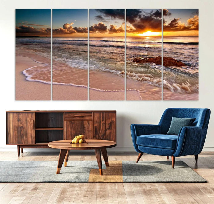 The Sunset Beach Waves Triptych Wall Art, featuring a tropical ocean scene on giclee canvas with a gallery wrap, adorns the wall in a cozy, coastal-themed living room.