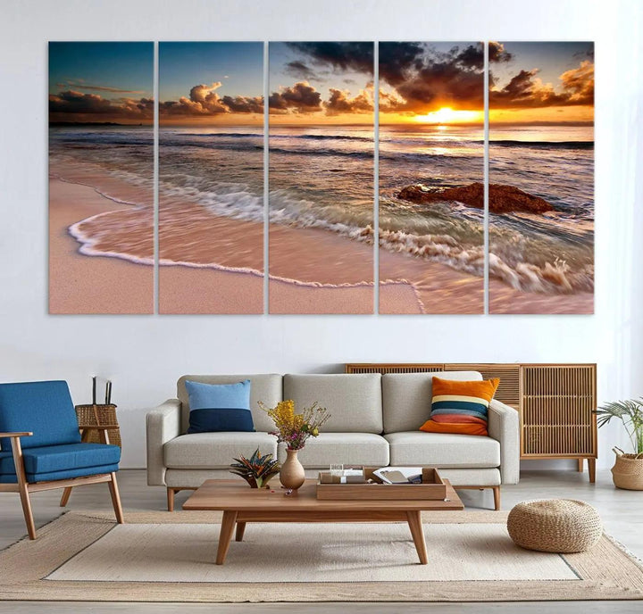 The Sunset Beach Waves Triptych Wall Art, featuring a tropical ocean scene on giclee canvas with a gallery wrap, adorns the wall in a cozy, coastal-themed living room.