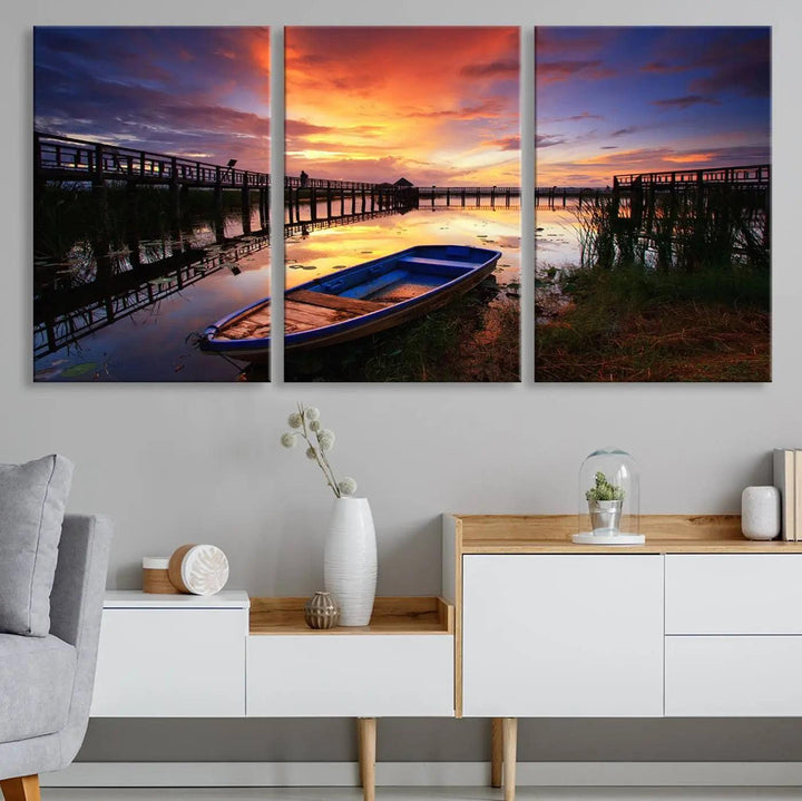 The "Sunset Boat Scene on Lake Triptych" beautifully captures a vibrant sunset over a calm lake. This tranquil scene, featuring serene reflections and surrounded by reeds, is printed on premium giclee canvas with Canon print quality. The gallery wrap design enhances every detail of tranquility.