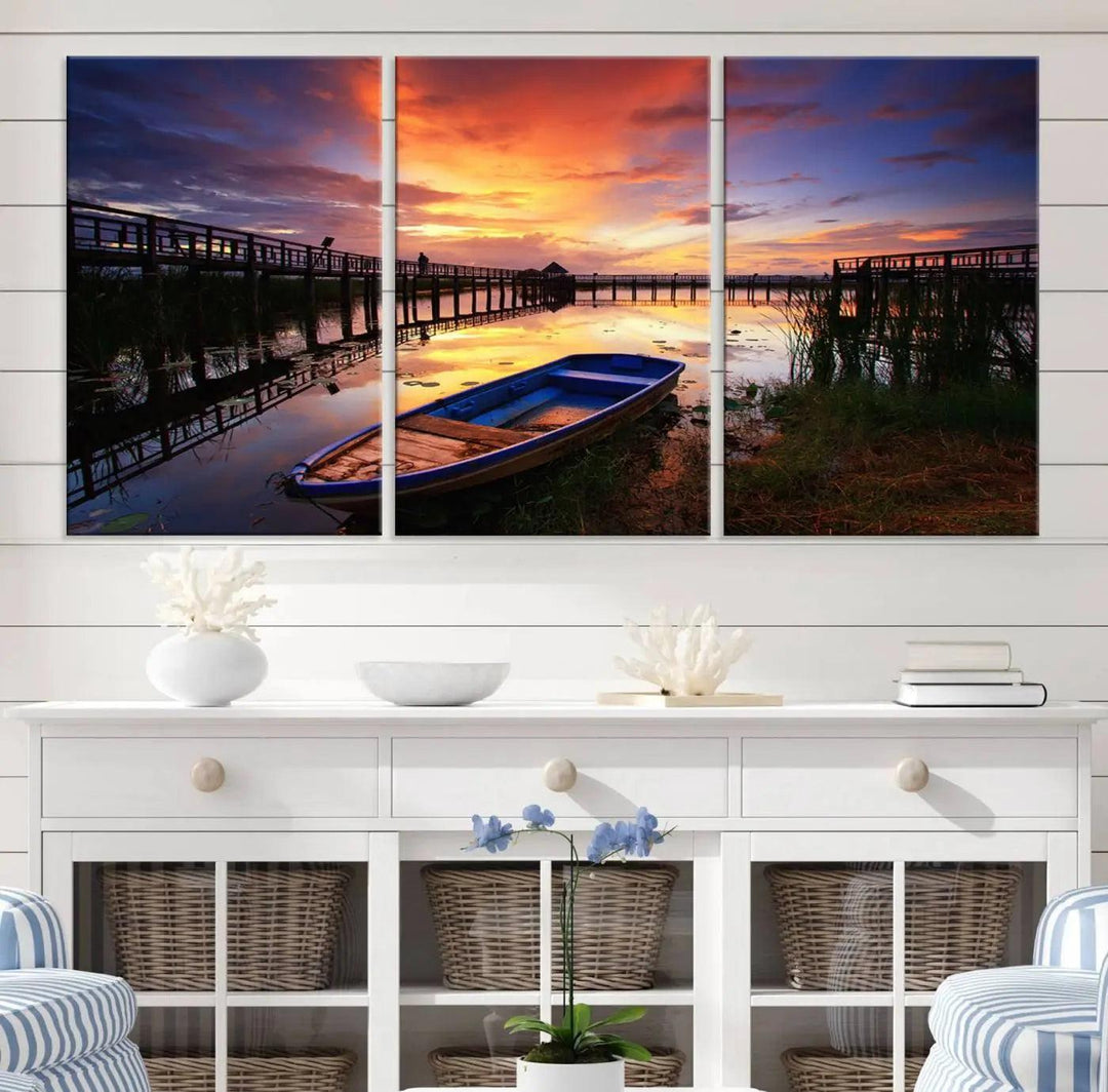 The "Sunset Boat Scene on Lake Triptych" beautifully captures a vibrant sunset over a calm lake. This tranquil scene, featuring serene reflections and surrounded by reeds, is printed on premium giclee canvas with Canon print quality. The gallery wrap design enhances every detail of tranquility.