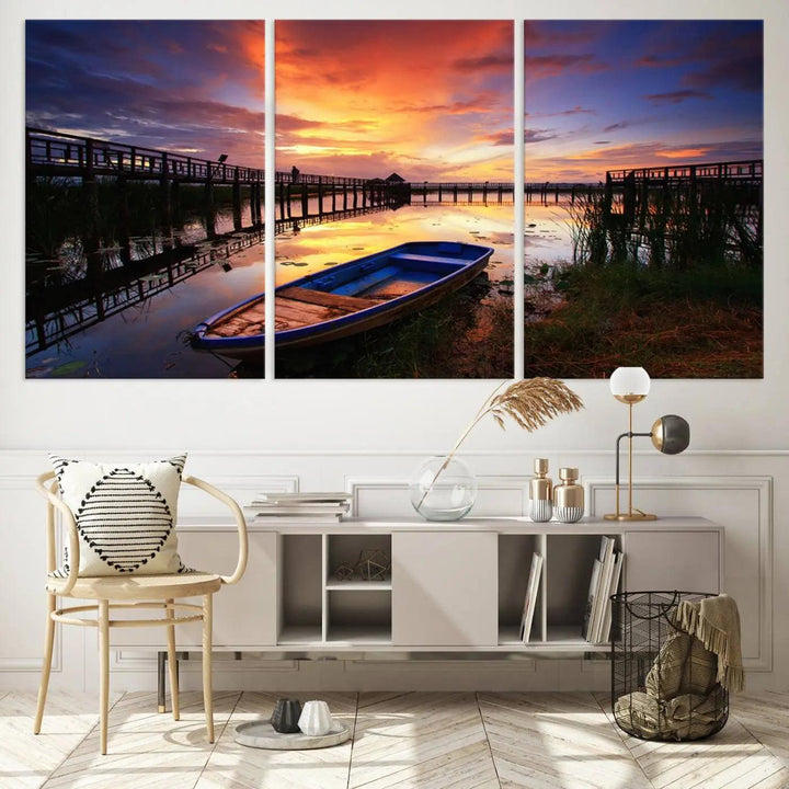 The "Sunset Boat Scene on Lake Triptych" beautifully captures a vibrant sunset over a calm lake. This tranquil scene, featuring serene reflections and surrounded by reeds, is printed on premium giclee canvas with Canon print quality. The gallery wrap design enhances every detail of tranquility.