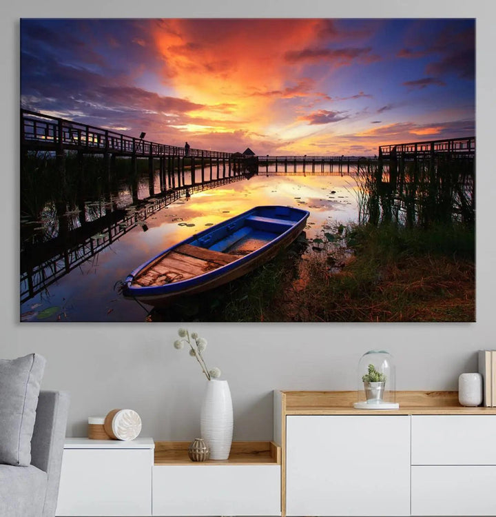 The "Sunset Boat Scene on Lake Triptych" beautifully captures a vibrant sunset over a calm lake. This tranquil scene, featuring serene reflections and surrounded by reeds, is printed on premium giclee canvas with Canon print quality. The gallery wrap design enhances every detail of tranquility.