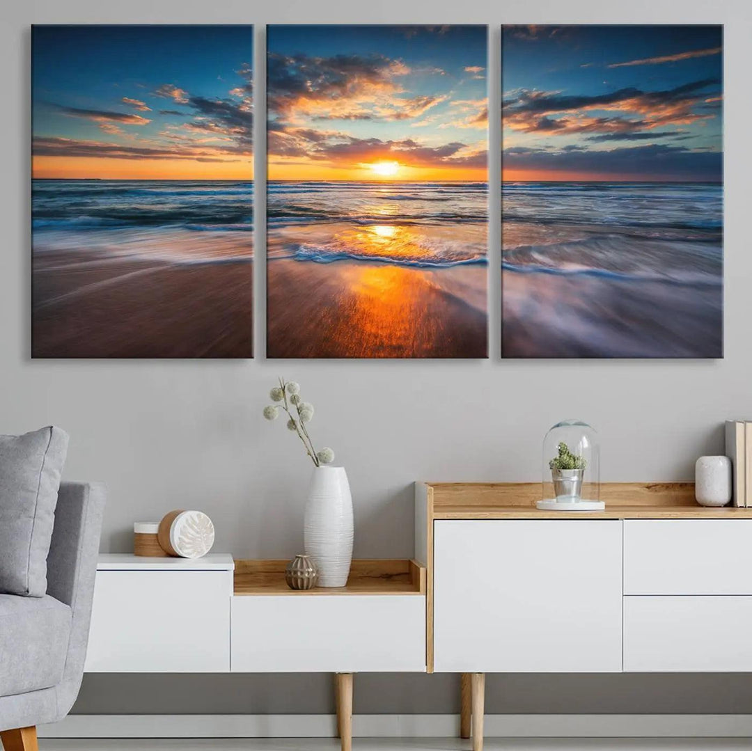 A triptych of "Sunset on the Ocean Beach with Waves," a vibrant coastal wall art print, showcases reflections on the sand during an ocean sunset.