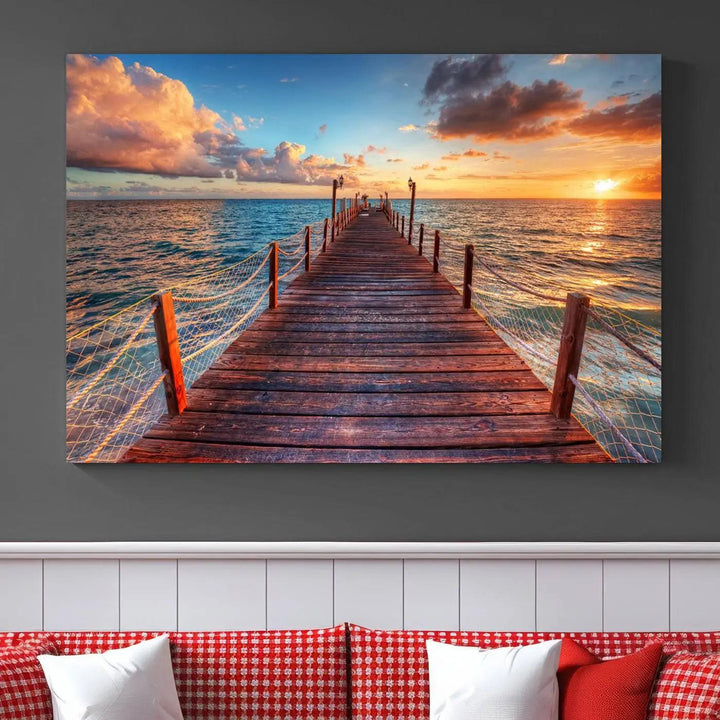 The Sunset Pier Canvas Wall Art is a triptych featuring an ocean landscape that elegantly captures a tranquil beach sunset with gentle ocean waves. It comes beautifully framed and ready to hang.