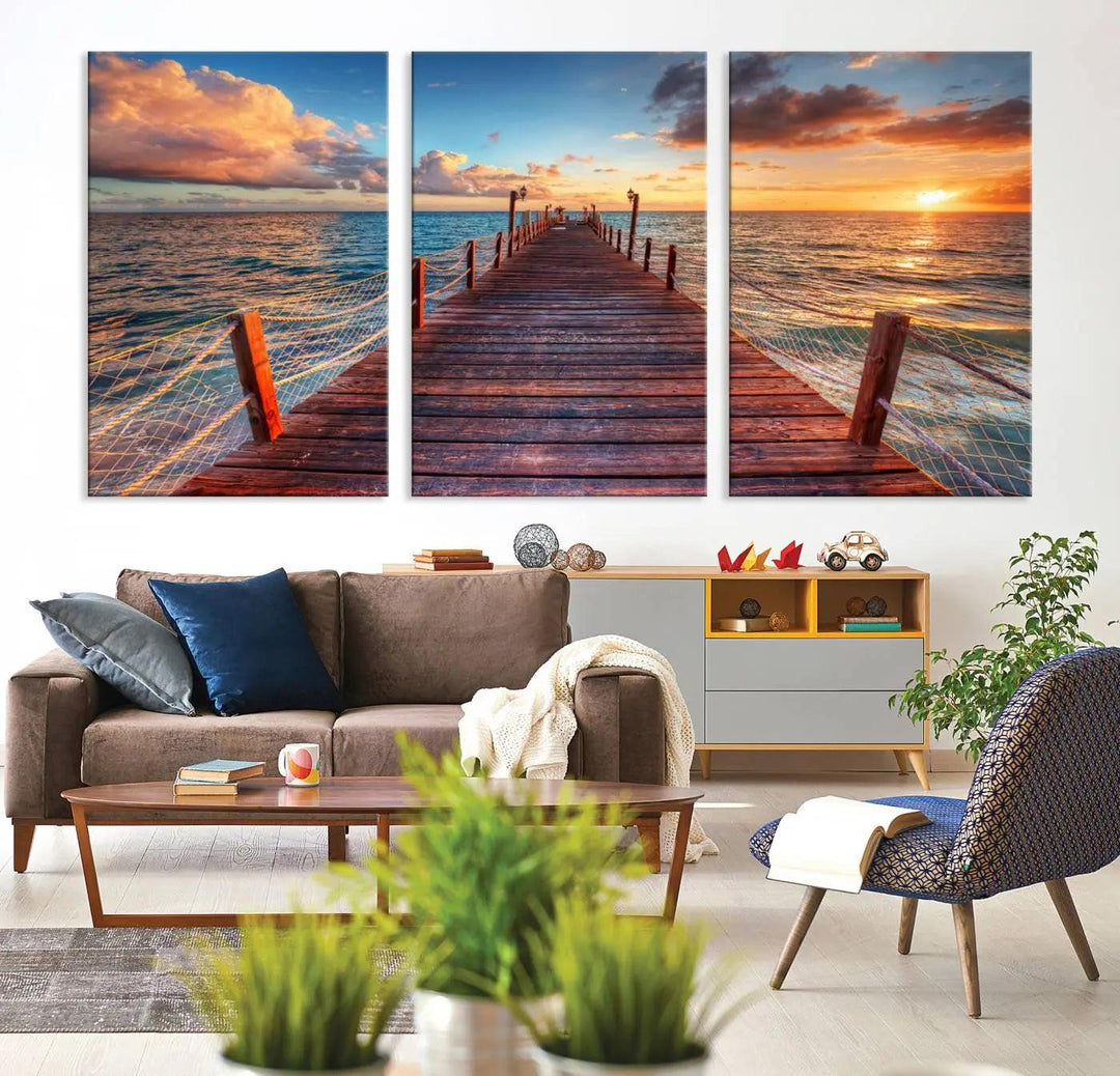 The Sunset Pier Canvas Wall Art is a triptych featuring an ocean landscape that elegantly captures a tranquil beach sunset with gentle ocean waves. It comes beautifully framed and ready to hang.