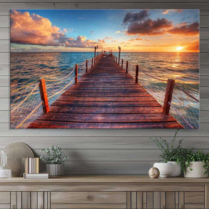 The Sunset Pier Canvas Wall Art is a triptych featuring an ocean landscape that elegantly captures a tranquil beach sunset with gentle ocean waves. It comes beautifully framed and ready to hang.