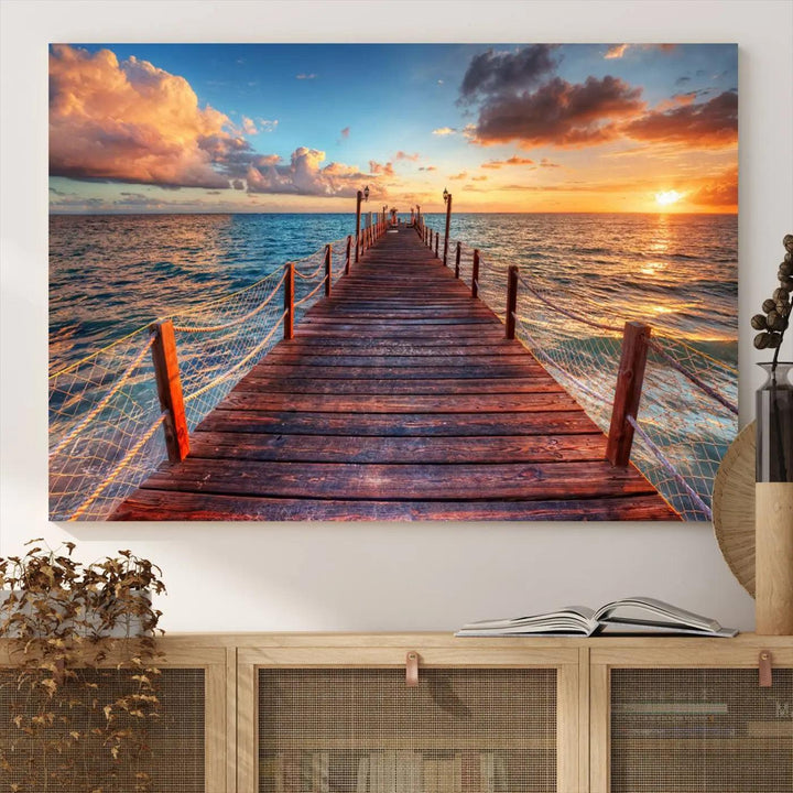 The Sunset Pier Canvas Wall Art is a triptych featuring an ocean landscape that elegantly captures a tranquil beach sunset with gentle ocean waves. It comes beautifully framed and ready to hang.