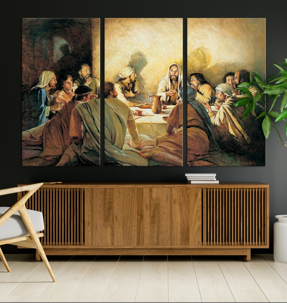 A cozy living room showcases a three-panel canvas titled "The Last Supper Canvas Wall Art – Sacred Religious Masterpiece," depicting people gathered at a table reminiscent of the Last Supper.