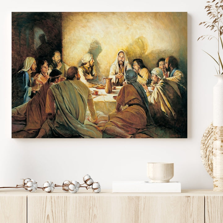 A cozy living room showcases a three-panel canvas titled "The Last Supper Canvas Wall Art – Sacred Religious Masterpiece," depicting people gathered at a table reminiscent of the Last Supper.