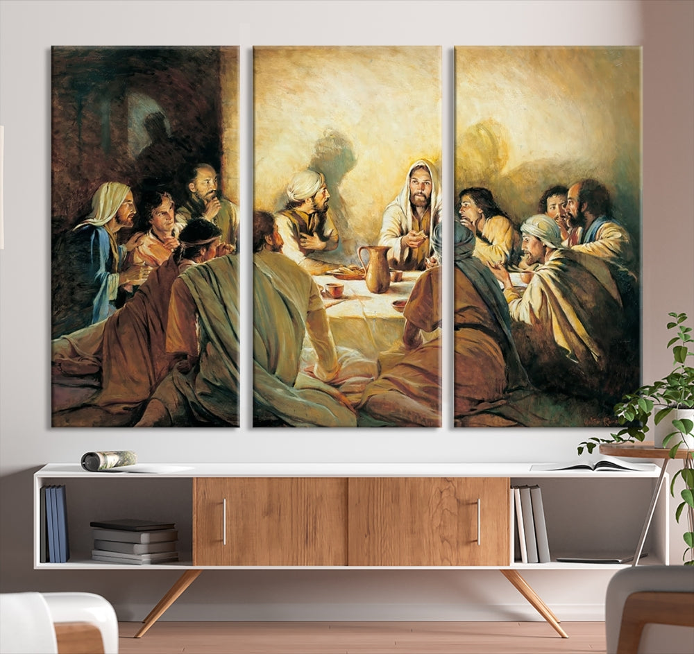 A cozy living room showcases a three-panel canvas titled "The Last Supper Canvas Wall Art – Sacred Religious Masterpiece," depicting people gathered at a table reminiscent of the Last Supper.