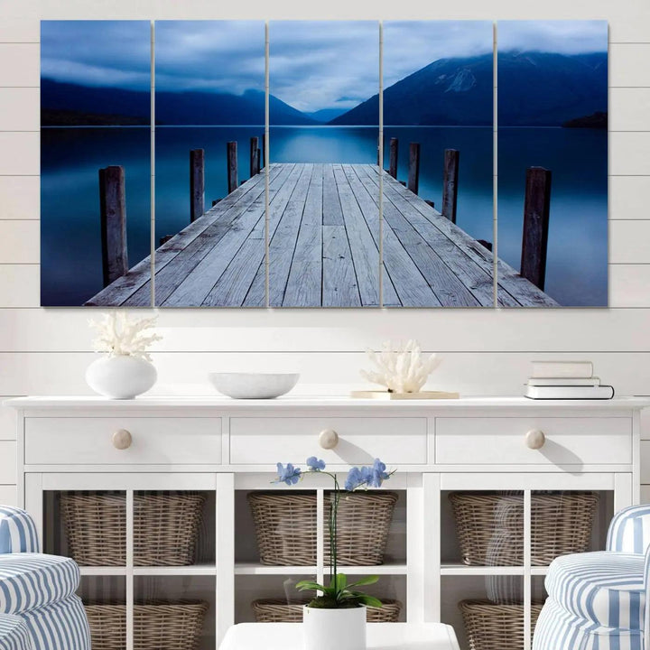 Tranquil lakeside pier triptych canvas art featuring a blue mountain horizon and serene dock. Perfect for modern interiors. High-quality giclee canvas print.