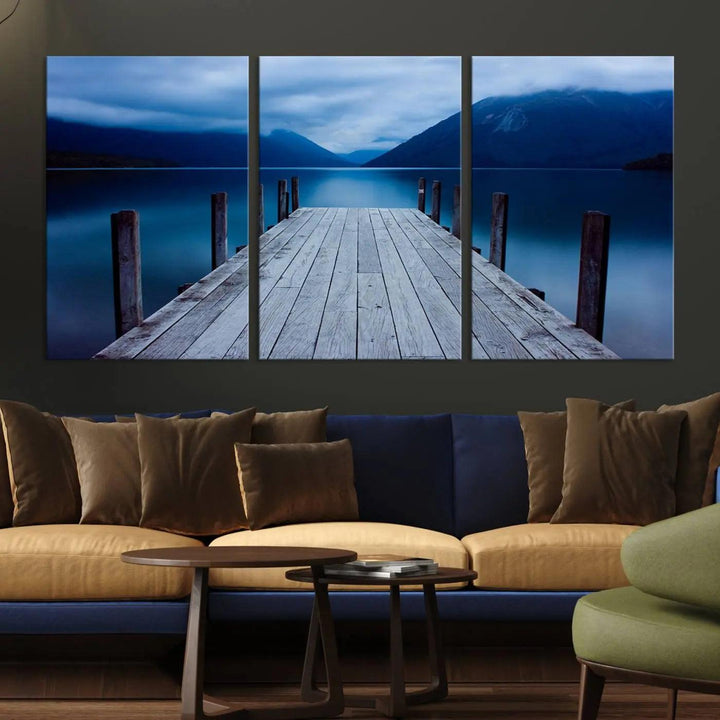 Tranquil lakeside pier triptych canvas art featuring a blue mountain horizon and serene dock. Perfect for modern interiors. High-quality giclee canvas print.