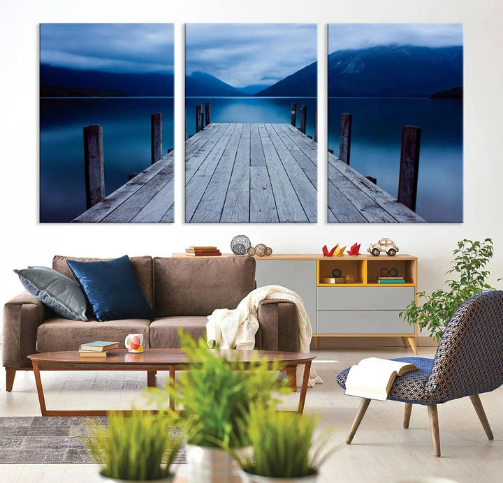 Tranquil lakeside pier triptych canvas art featuring a blue mountain horizon and serene dock. Perfect for modern interiors. High-quality giclee canvas print.