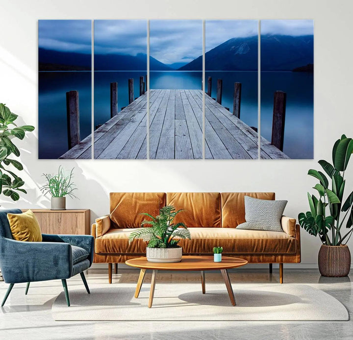 Tranquil lakeside pier triptych canvas art featuring a blue mountain horizon and serene dock. Perfect for modern interiors. High-quality giclee canvas print.