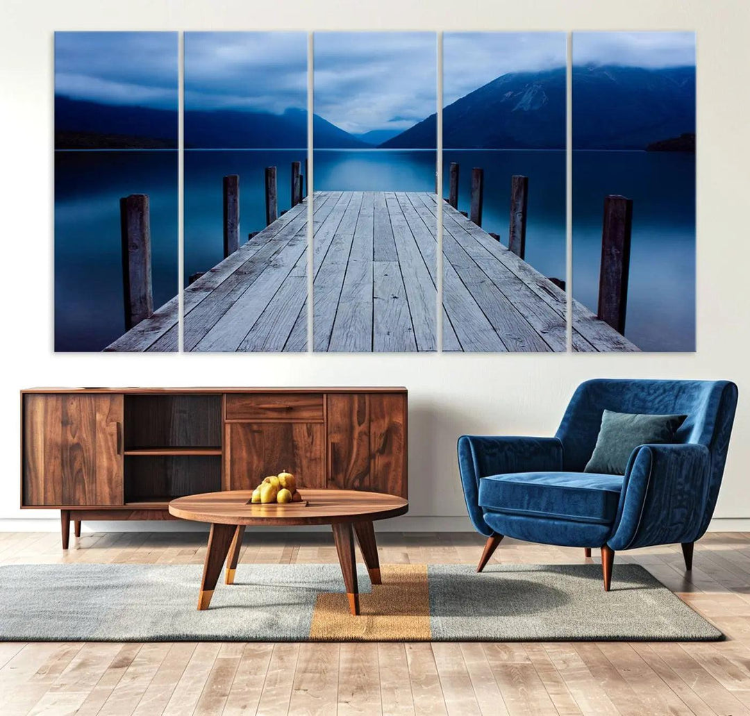 Tranquil lakeside pier triptych canvas art featuring a blue mountain horizon and serene dock. Perfect for modern interiors. High-quality giclee canvas print.