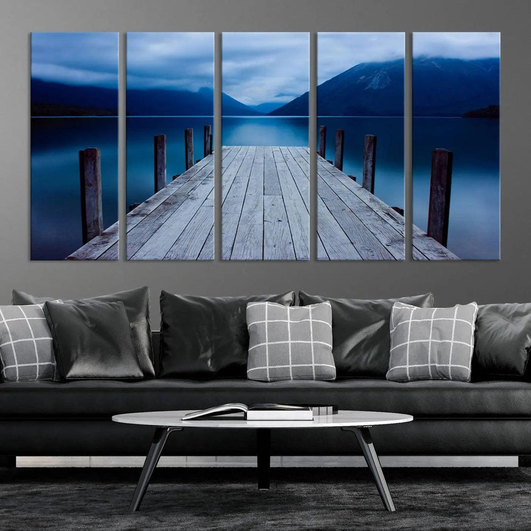 Tranquil lakeside pier triptych canvas art featuring a blue mountain horizon and serene dock. Perfect for modern interiors. High-quality giclee canvas print.