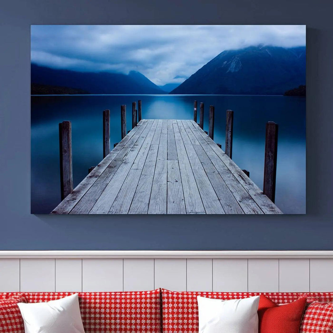 Tranquil lakeside pier triptych canvas art featuring a blue mountain horizon and serene dock. Perfect for modern interiors. High-quality giclee canvas print.