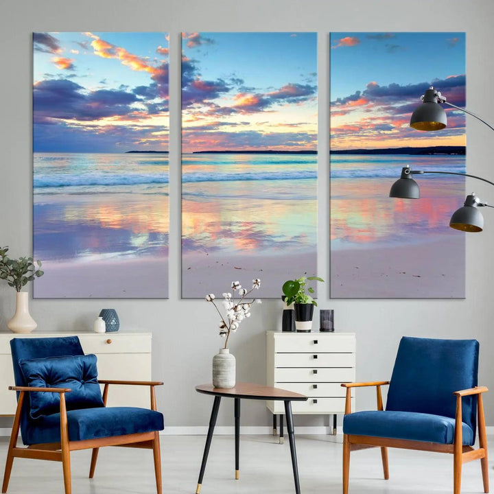 A modern living room is accentuated by a stunning Tranquil Pastel Sunset Beach Triptych Canvas Art on the wall, epitomizing coastal home decor elegance.