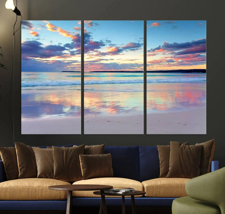 A modern living room is accentuated by a stunning Tranquil Pastel Sunset Beach Triptych Canvas Art on the wall, epitomizing coastal home decor elegance.