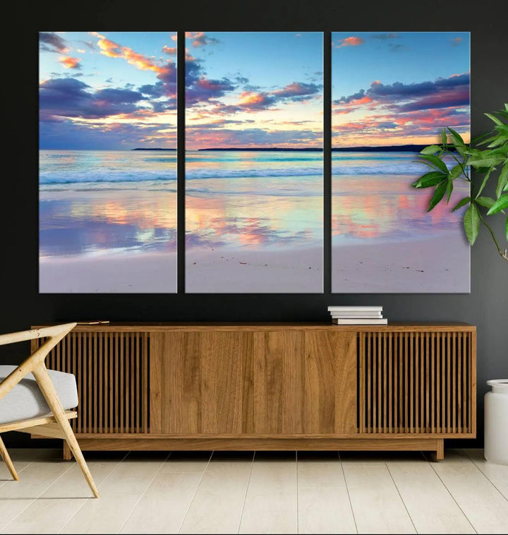 A modern living room is accentuated by a stunning Tranquil Pastel Sunset Beach Triptych Canvas Art on the wall, epitomizing coastal home decor elegance.