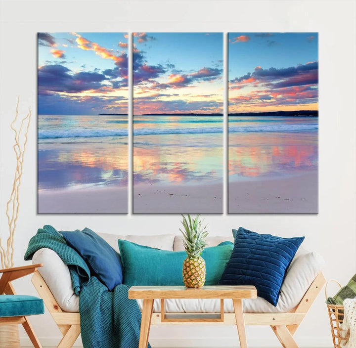 A modern living room is accentuated by a stunning Tranquil Pastel Sunset Beach Triptych Canvas Art on the wall, epitomizing coastal home decor elegance.