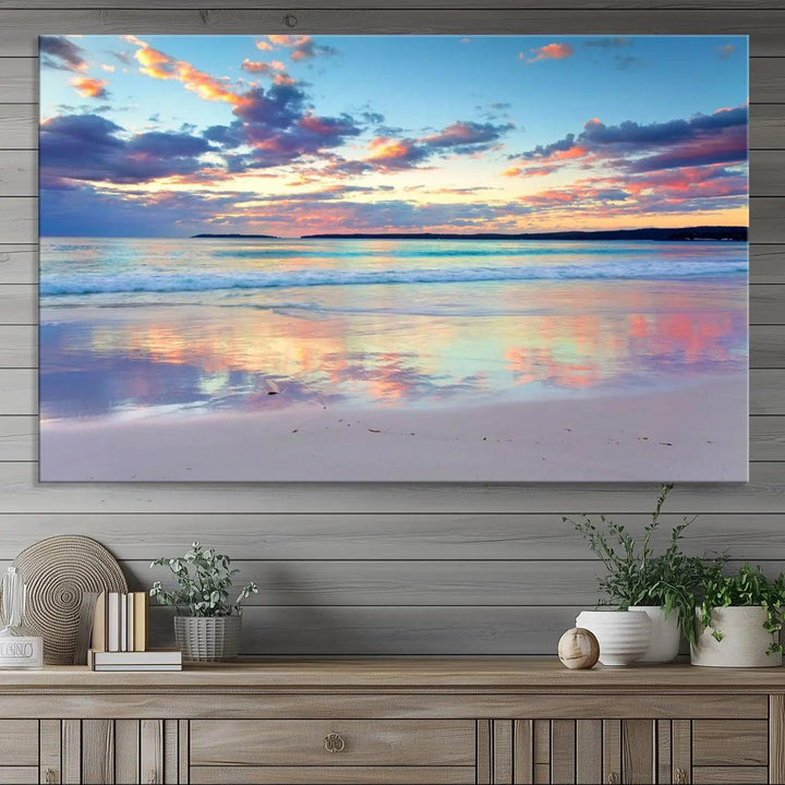 A modern living room is accentuated by a stunning Tranquil Pastel Sunset Beach Triptych Canvas Art on the wall, epitomizing coastal home decor elegance.