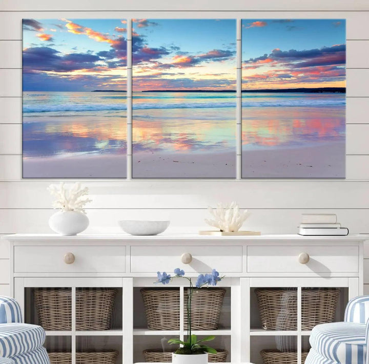 A modern living room is accentuated by a stunning Tranquil Pastel Sunset Beach Triptych Canvas Art on the wall, epitomizing coastal home decor elegance.