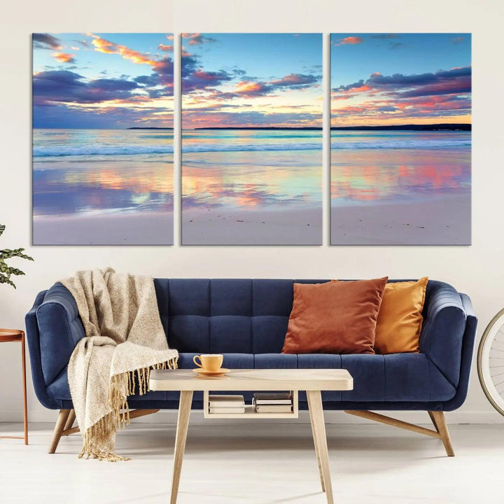 A modern living room is accentuated by a stunning Tranquil Pastel Sunset Beach Triptych Canvas Art on the wall, epitomizing coastal home decor elegance.