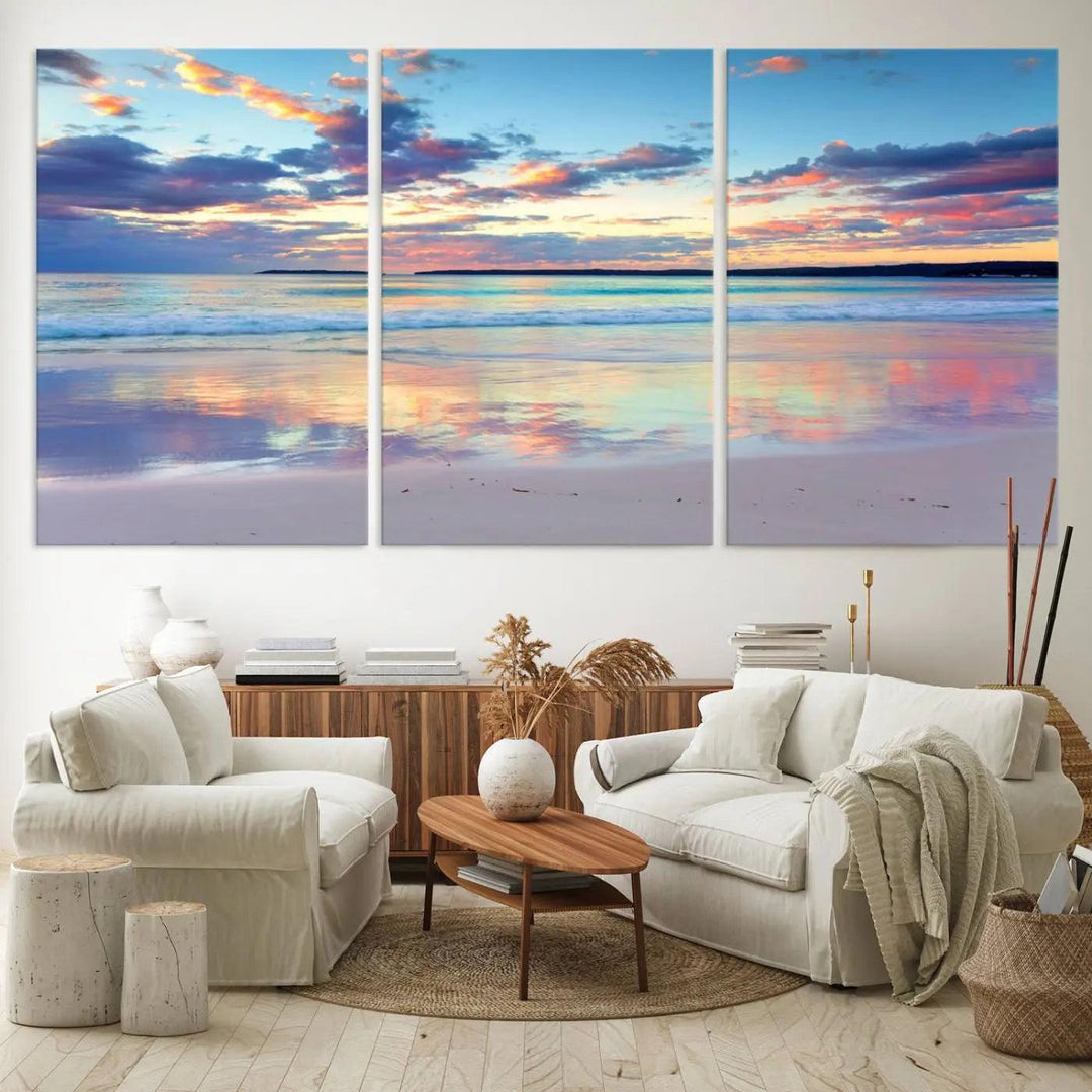 A modern living room is accentuated by a stunning Tranquil Pastel Sunset Beach Triptych Canvas Art on the wall, epitomizing coastal home decor elegance.