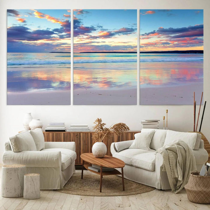 A modern living room is accentuated by a stunning Tranquil Pastel Sunset Beach Triptych Canvas Art on the wall, epitomizing coastal home decor elegance.