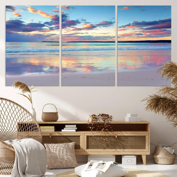 A modern living room is accentuated by a stunning Tranquil Pastel Sunset Beach Triptych Canvas Art on the wall, epitomizing coastal home decor elegance.