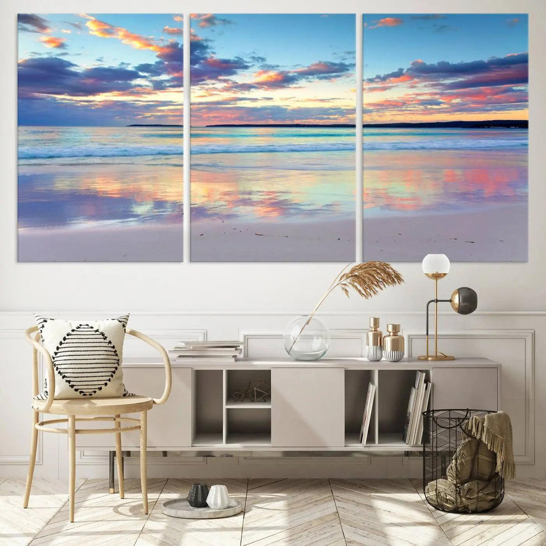 A modern living room is accentuated by a stunning Tranquil Pastel Sunset Beach Triptych Canvas Art on the wall, epitomizing coastal home decor elegance.