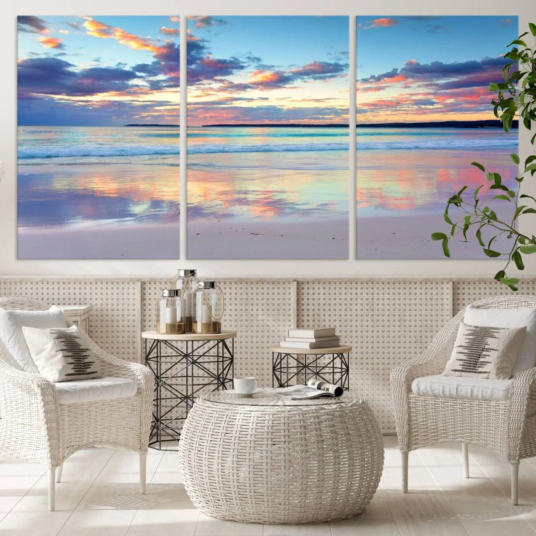 A modern living room is accentuated by a stunning Tranquil Pastel Sunset Beach Triptych Canvas Art on the wall, epitomizing coastal home decor elegance.