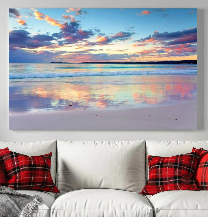 A modern living room is accentuated by a stunning Tranquil Pastel Sunset Beach Triptych Canvas Art on the wall, epitomizing coastal home decor elegance.