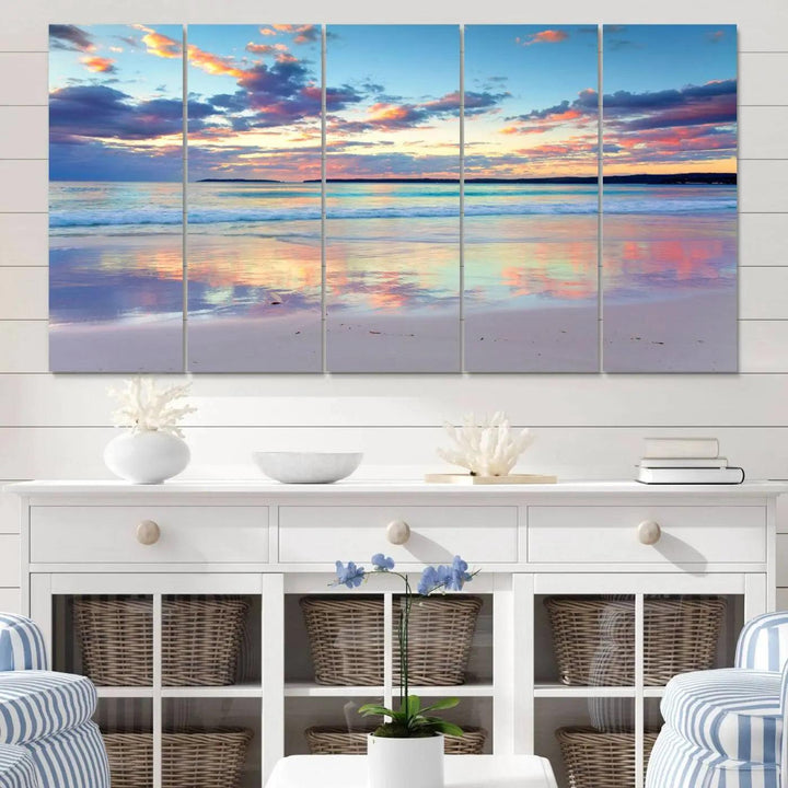 A modern living room is accentuated by a stunning Tranquil Pastel Sunset Beach Triptych Canvas Art on the wall, epitomizing coastal home decor elegance.