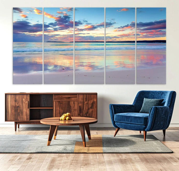 A modern living room is accentuated by a stunning Tranquil Pastel Sunset Beach Triptych Canvas Art on the wall, epitomizing coastal home decor elegance.