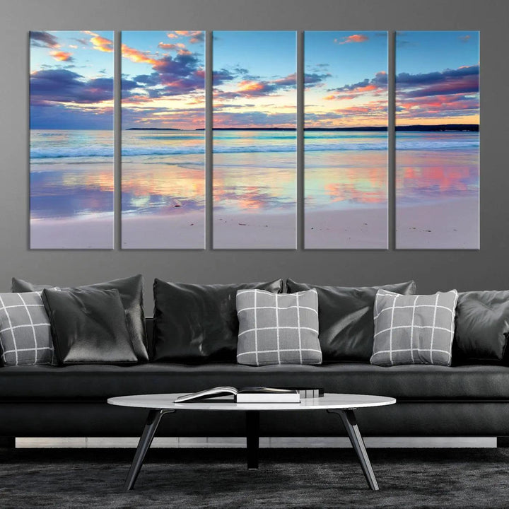 A modern living room is accentuated by a stunning Tranquil Pastel Sunset Beach Triptych Canvas Art on the wall, epitomizing coastal home decor elegance.