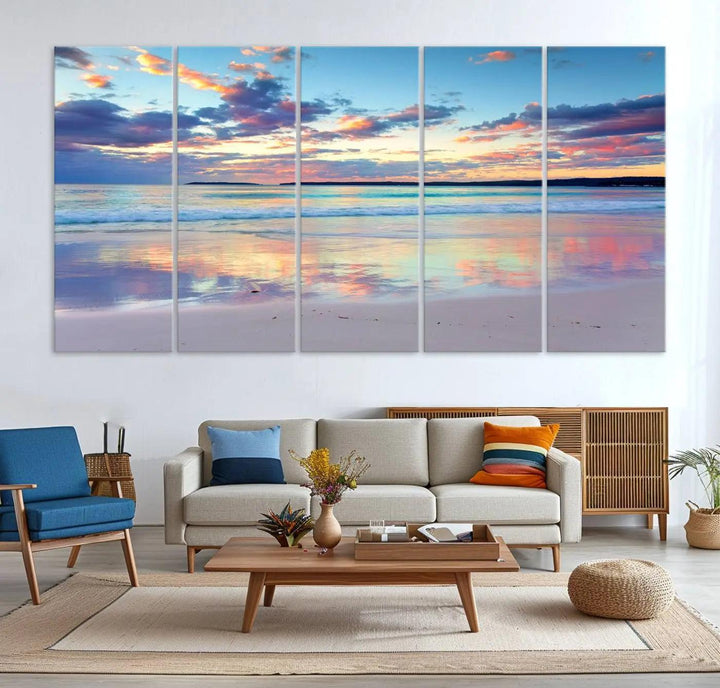 A modern living room is accentuated by a stunning Tranquil Pastel Sunset Beach Triptych Canvas Art on the wall, epitomizing coastal home decor elegance.