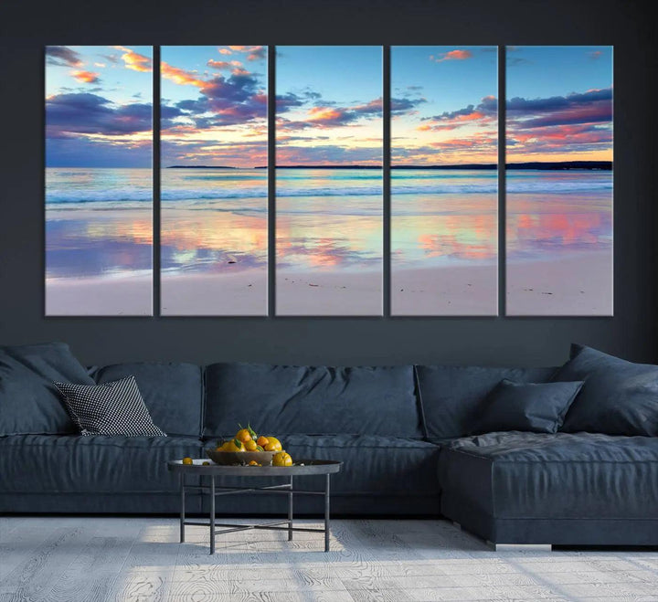 A modern living room is accentuated by a stunning Tranquil Pastel Sunset Beach Triptych Canvas Art on the wall, epitomizing coastal home decor elegance.