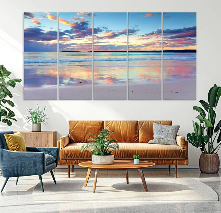 A modern living room is accentuated by a stunning Tranquil Pastel Sunset Beach Triptych Canvas Art on the wall, epitomizing coastal home decor elegance.