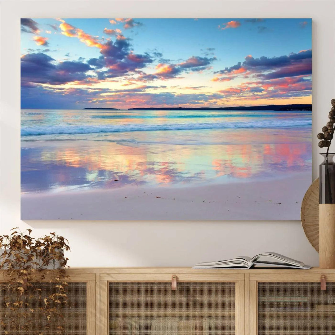 A modern living room is accentuated by a stunning Tranquil Pastel Sunset Beach Triptych Canvas Art on the wall, epitomizing coastal home decor elegance.