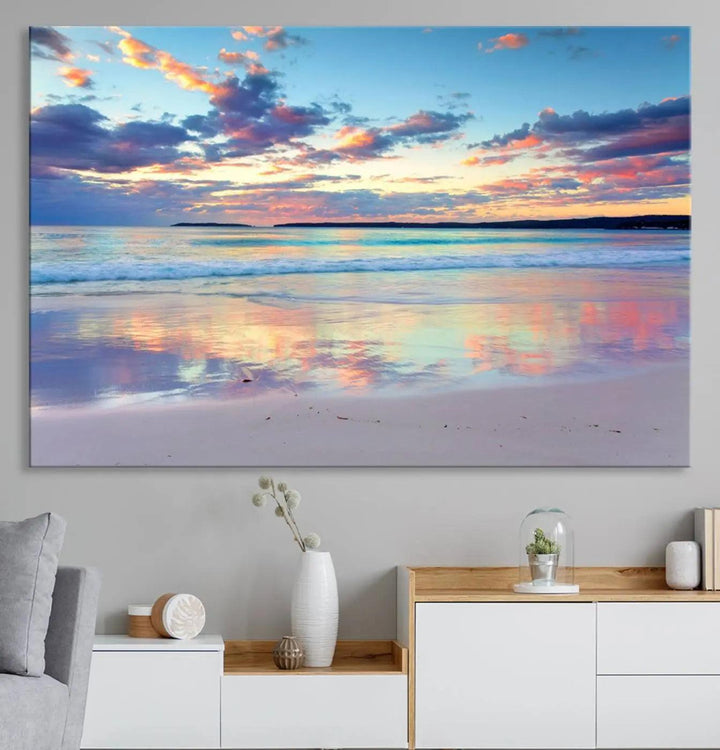 A modern living room is accentuated by a stunning Tranquil Pastel Sunset Beach Triptych Canvas Art on the wall, epitomizing coastal home decor elegance.