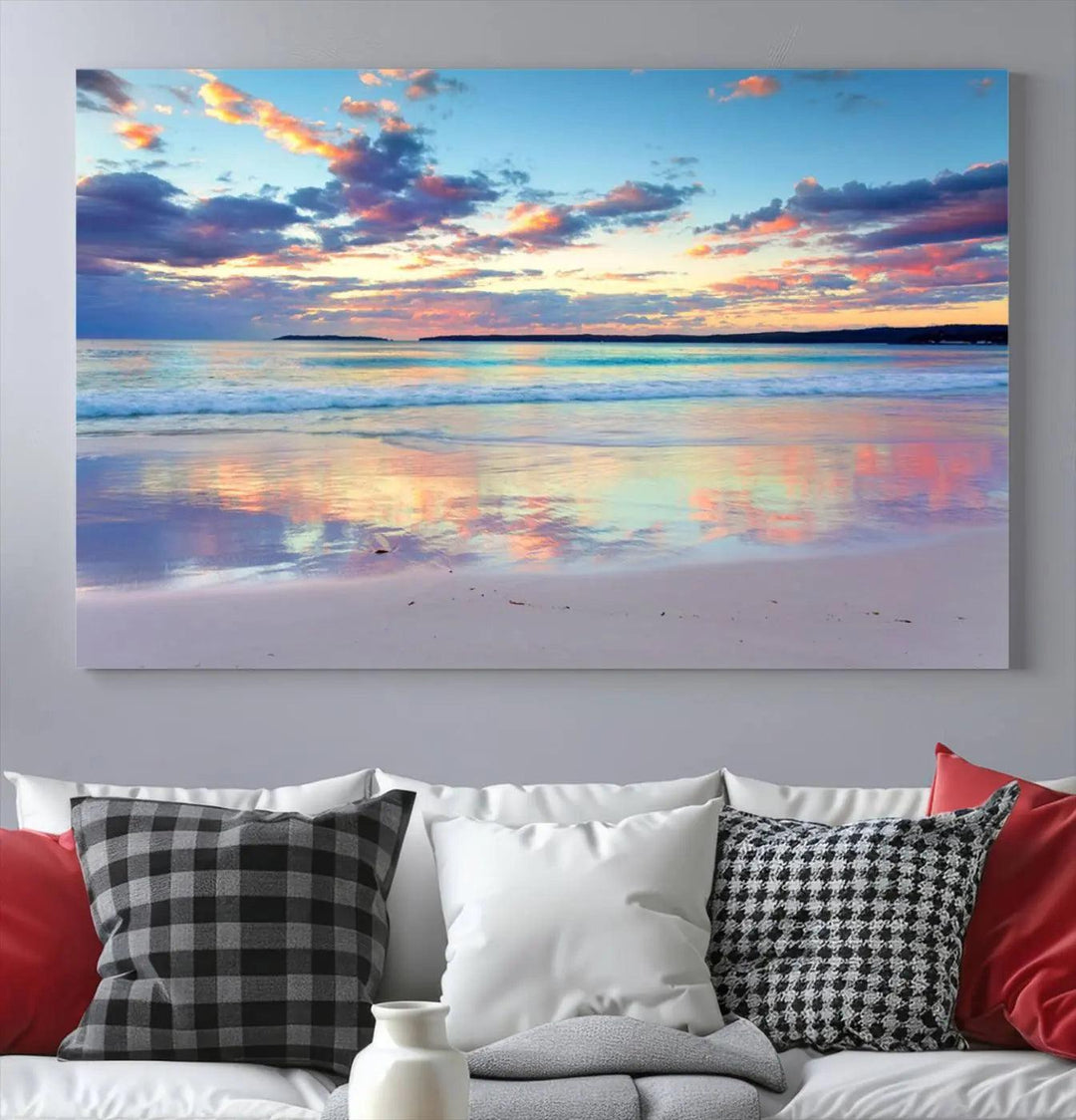 A modern living room is accentuated by a stunning Tranquil Pastel Sunset Beach Triptych Canvas Art on the wall, epitomizing coastal home decor elegance.