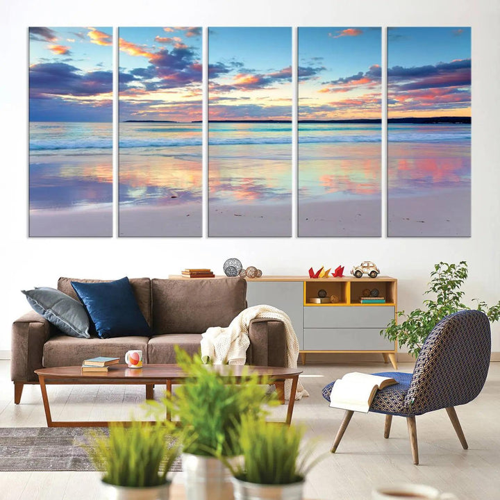 A modern living room is accentuated by a stunning Tranquil Pastel Sunset Beach Triptych Canvas Art on the wall, epitomizing coastal home decor elegance.