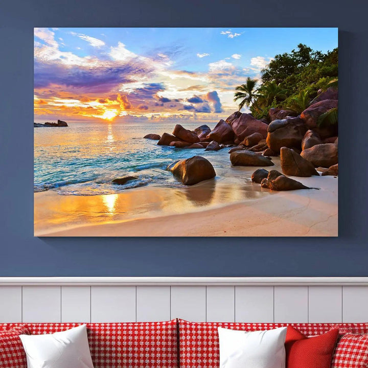 Tropical beach sunset canvas print featuring ocean waves and rocky shoreline. Coastal decor printed on giclee canvas with high-quality Canon print technology.