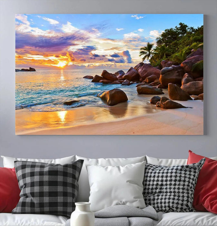 Tropical beach sunset canvas print featuring ocean waves and rocky shoreline. Coastal decor printed on giclee canvas with high-quality Canon print technology.