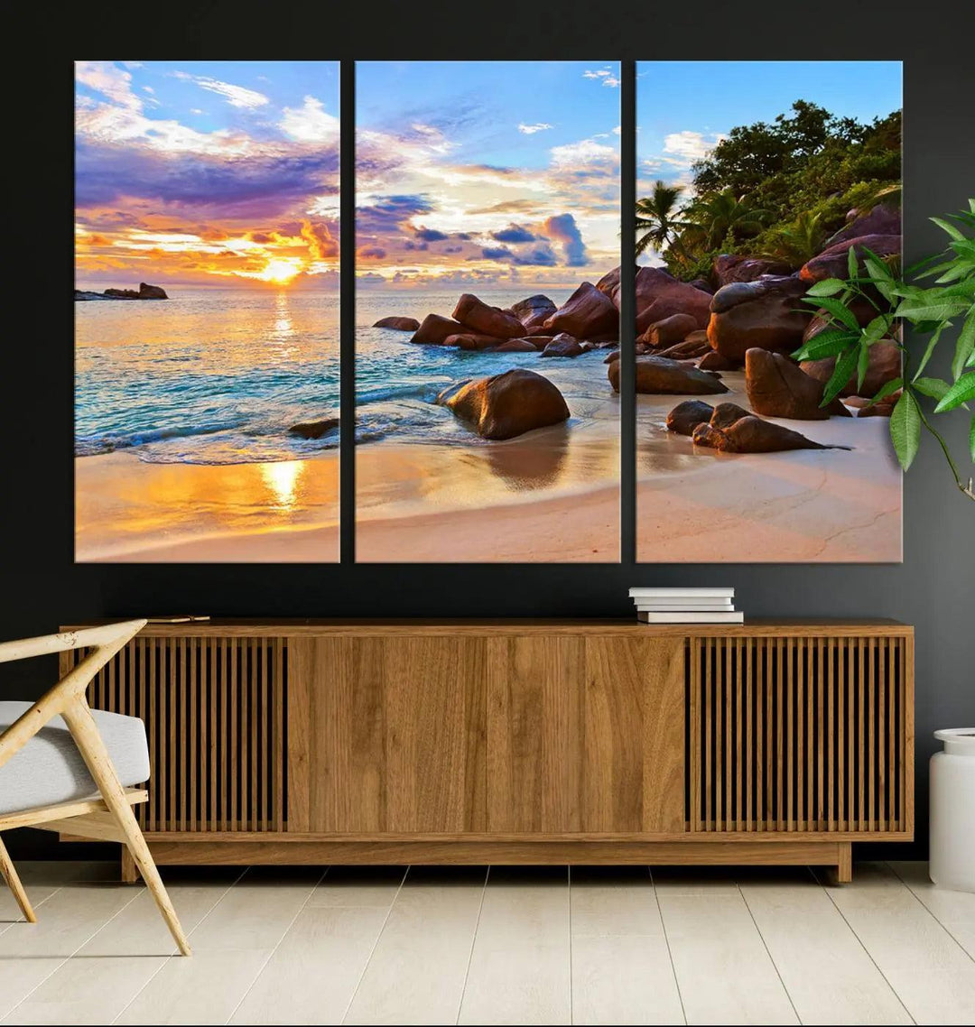 Tropical beach sunset canvas print featuring ocean waves and rocky shoreline. Coastal decor printed on giclee canvas with high-quality Canon print technology.